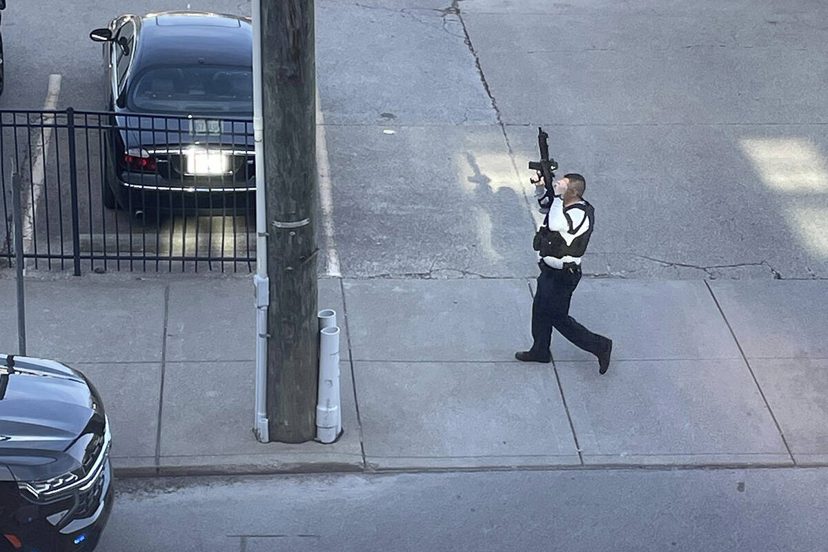 This photo provided by Reid Cornell shows police presence near the scene of a shooting in Louis ...