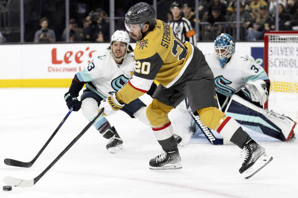 Golden Knights center Chandler Stephenson (20) passes while Seattle Kraken left wing Brandon Ta ...