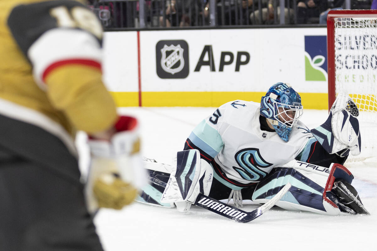 Seattle Kraken goaltender Joey Daccord (35) saves a shot by Golden Knights right wing Reilly Sm ...