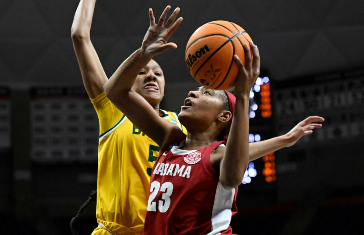 Alabama's Brittany Davis (23) goes up to the basket as Baylor's Darianna Littlepage-Buggs (5) d ...