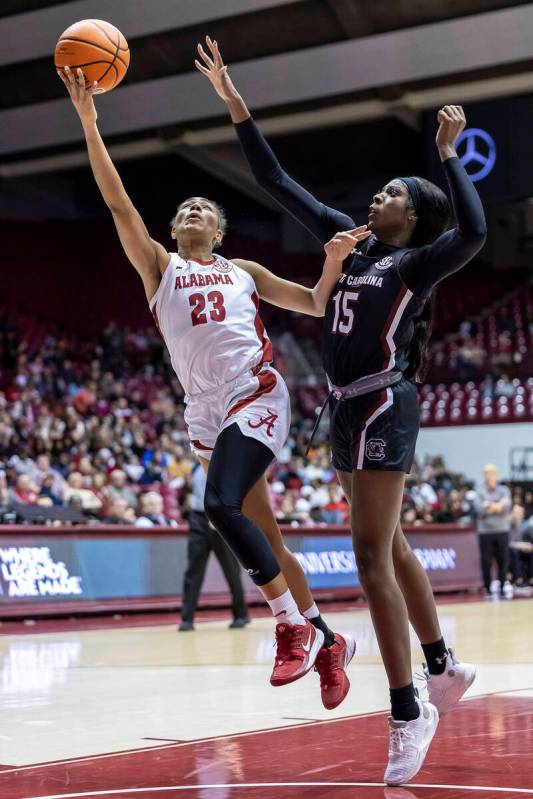 Alabama guard Brittany Davis (23) takes a shot with South Carolina forward Laeticia Amihere (15 ...