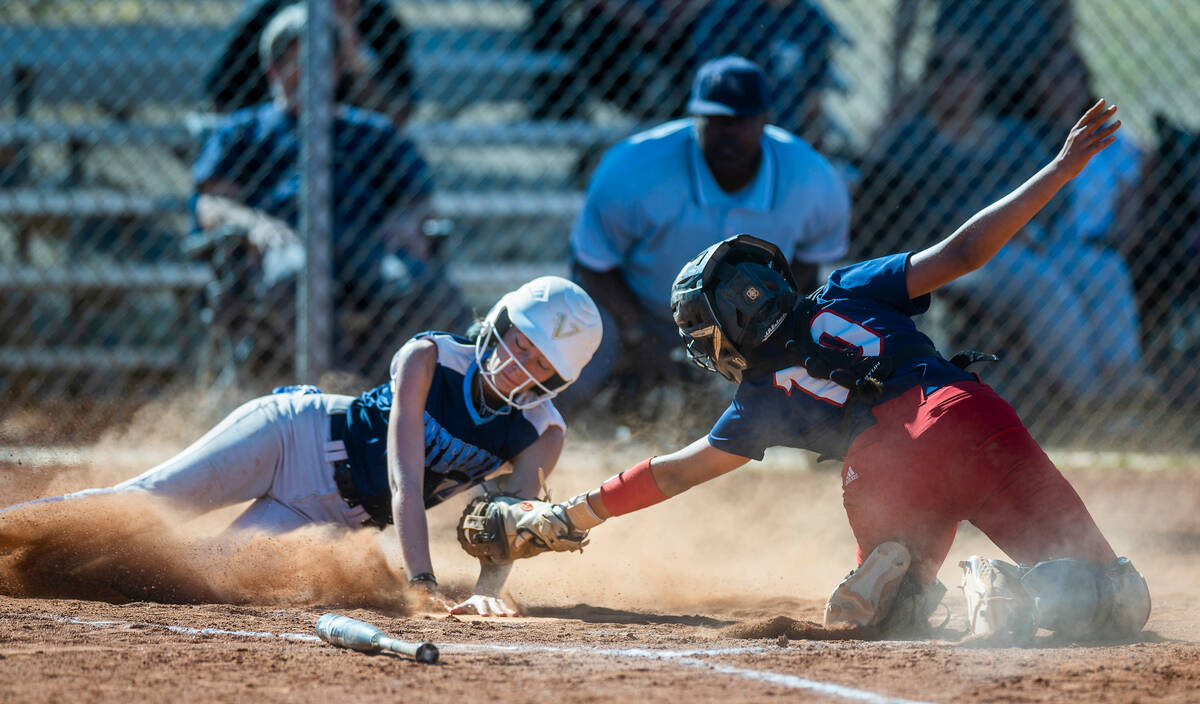 Centennial runner Sydnee Hartley scores past Liberty catcher Vanessa Saenz in the second inning ...