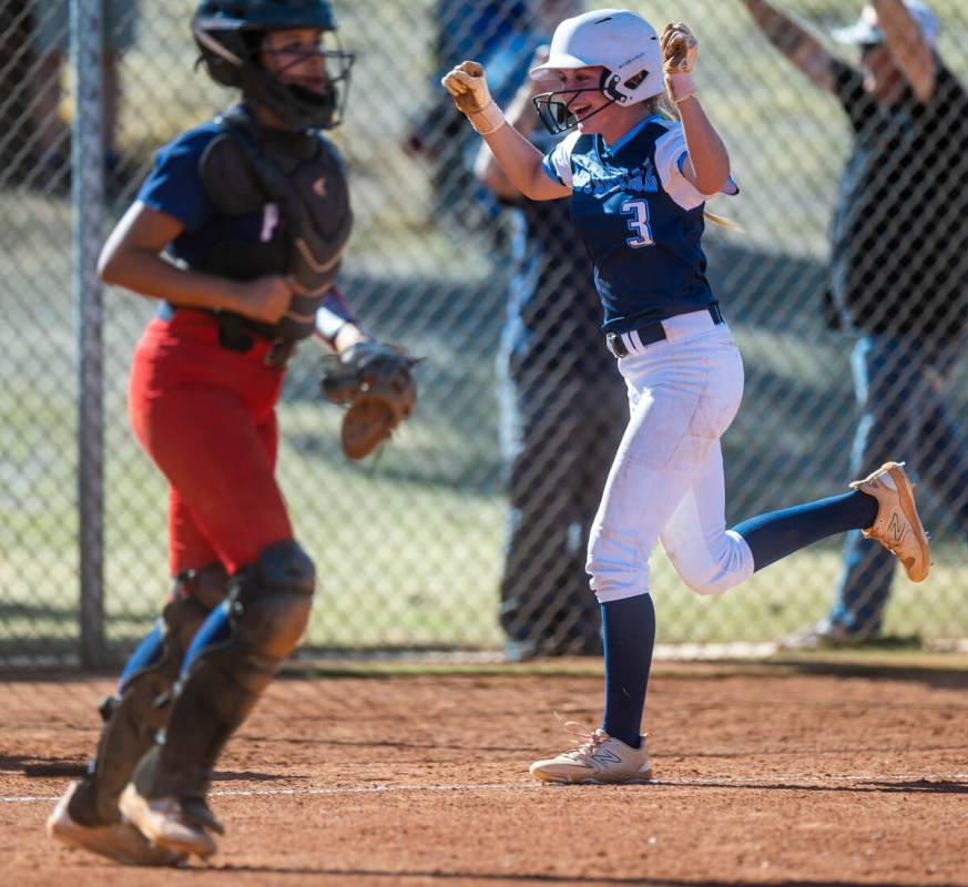 Centennial runner Ashley Madonia celebrates as she scores past Liberty catcher Vanessa Saenz in ...