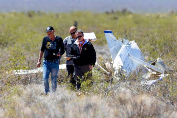 Officials from the FAA investigate a plane crash where two people died, on Tuesday, April 11, 2 ...