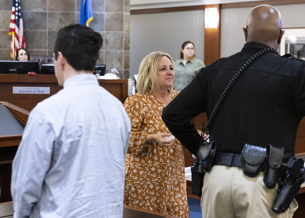 Ronda Bowman, center, the mother of drug overdose victim Shane Bowman, walks past Edward Romero ...