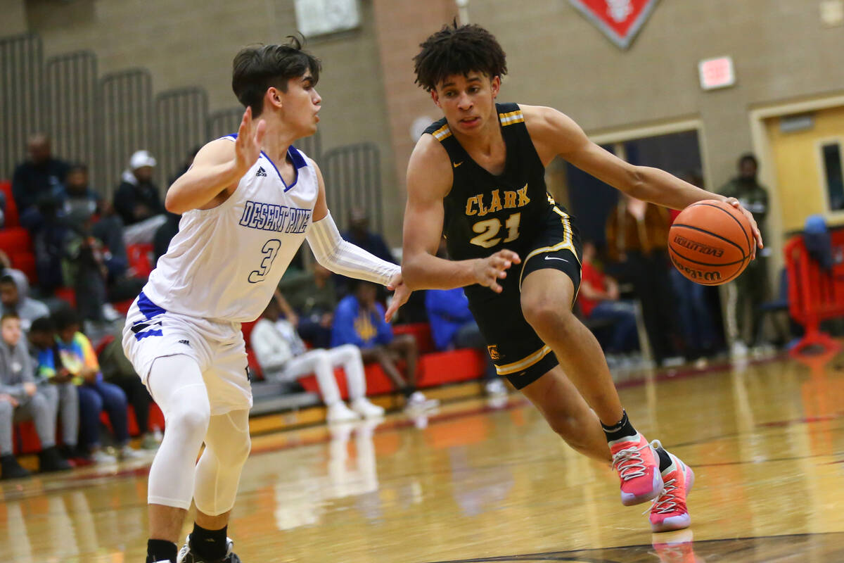 Clark's Jalen Hill (21) moves the ball around Desert Pines' Cimarron Conriquez (3) during the s ...