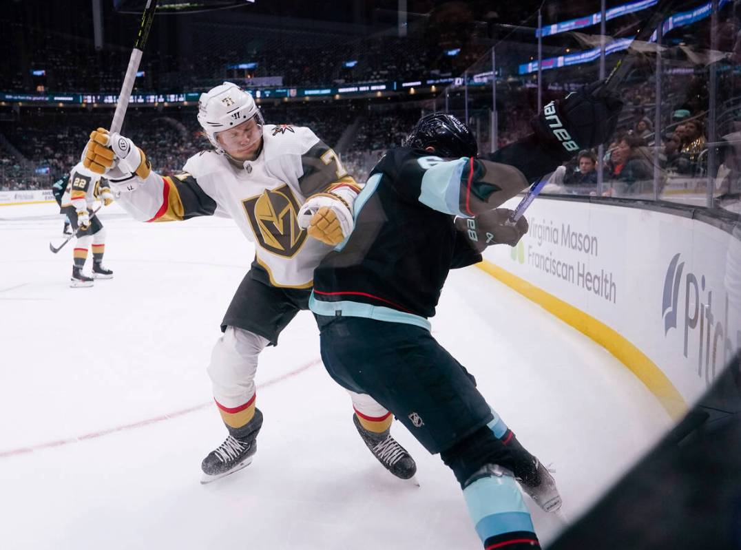 Vegas Golden Knights center William Karlsson, left, collides with Seattle Kraken center Morgan ...