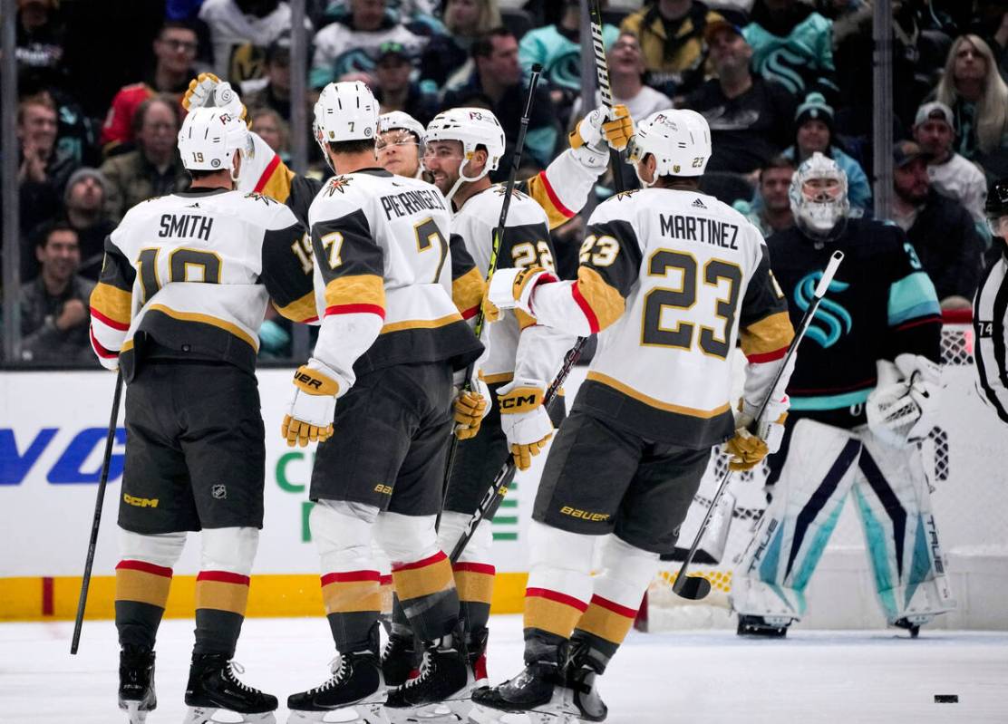 Vegas Golden Knights right wing Reilly Smith, left, celebrates a goal against the Seattle Krake ...