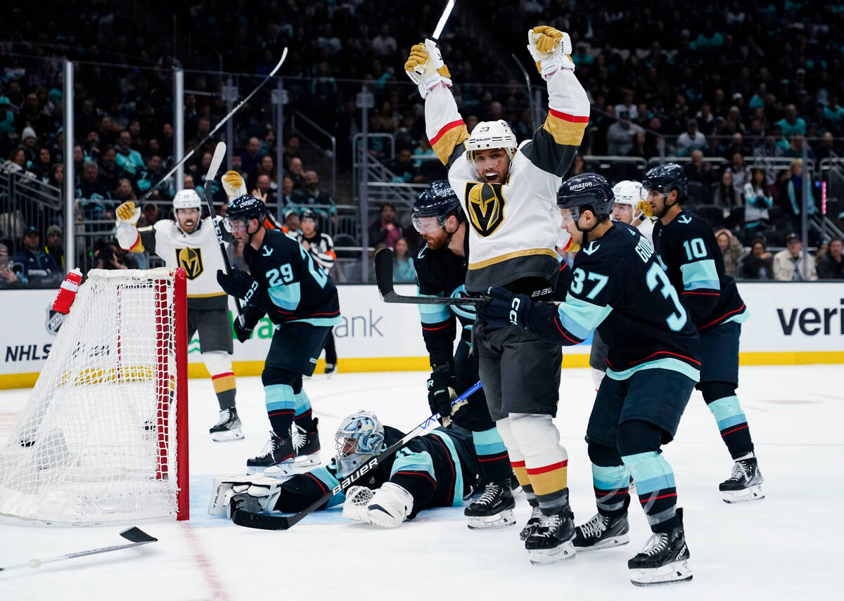 Vegas Golden Knights defenseman Alec Martinez, front left, celebrates his goal against Seattle ...