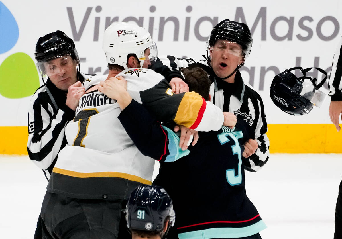 Vegas Golden Knights defenseman Alex Pietrangelo, left, knocks the helmet off of Seattle Kraken ...