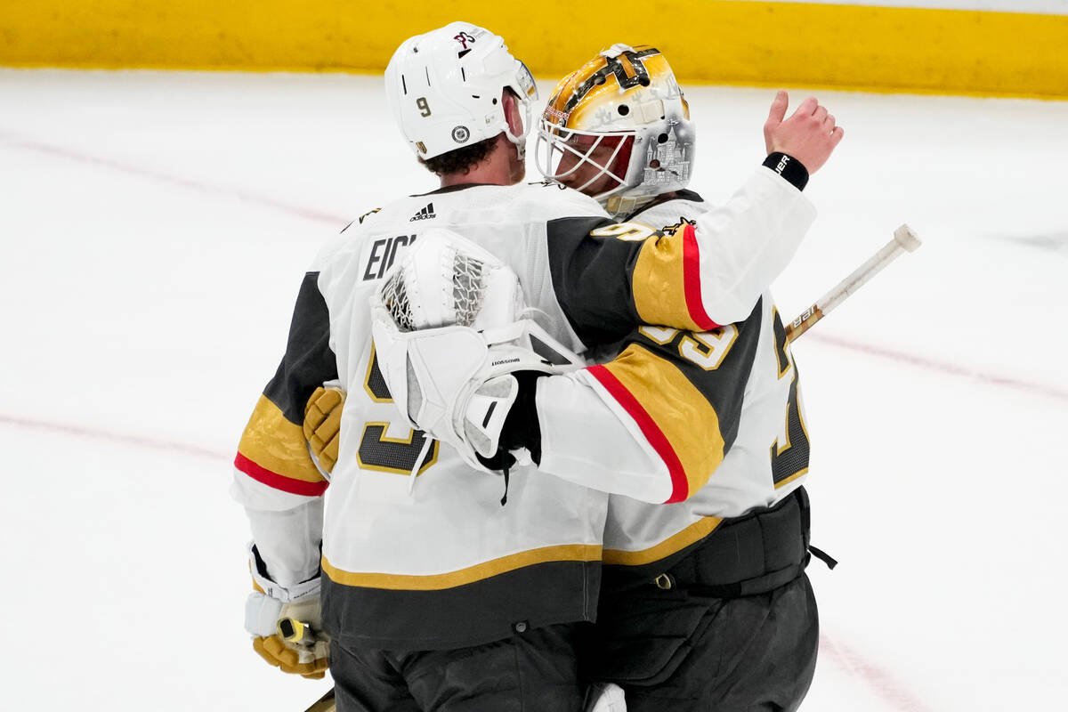 Vegas Golden Knights center Jack Eichel, left, greets goaltender Laurent Brossoit as they celeb ...