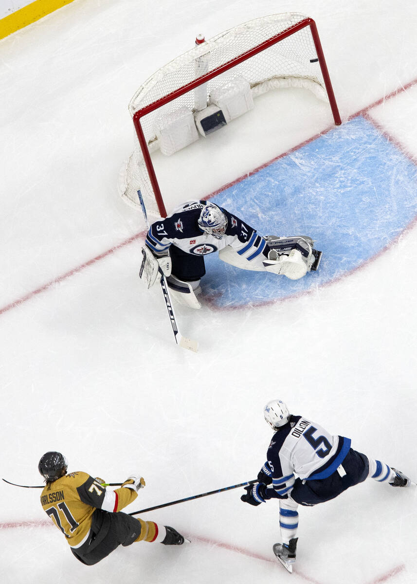 Golden Knights center William Karlsson (71) scores on Jets goaltender Connor Hellebuyck (37) wh ...