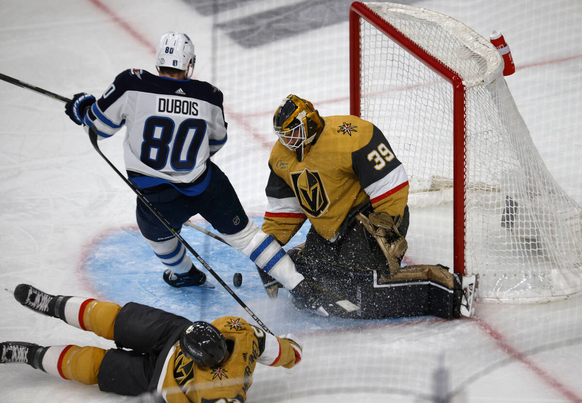 Golden Knights goaltender Laurent Brossoit (39) makes a save against Winnipeg Jets left wing Pi ...