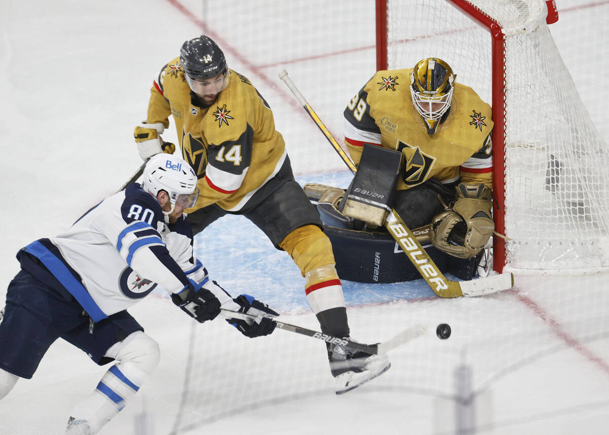 Winnipeg Jets left wing Pierre-Luc Dubois (80) shoots the puck Golden Knights defenseman Nicol ...