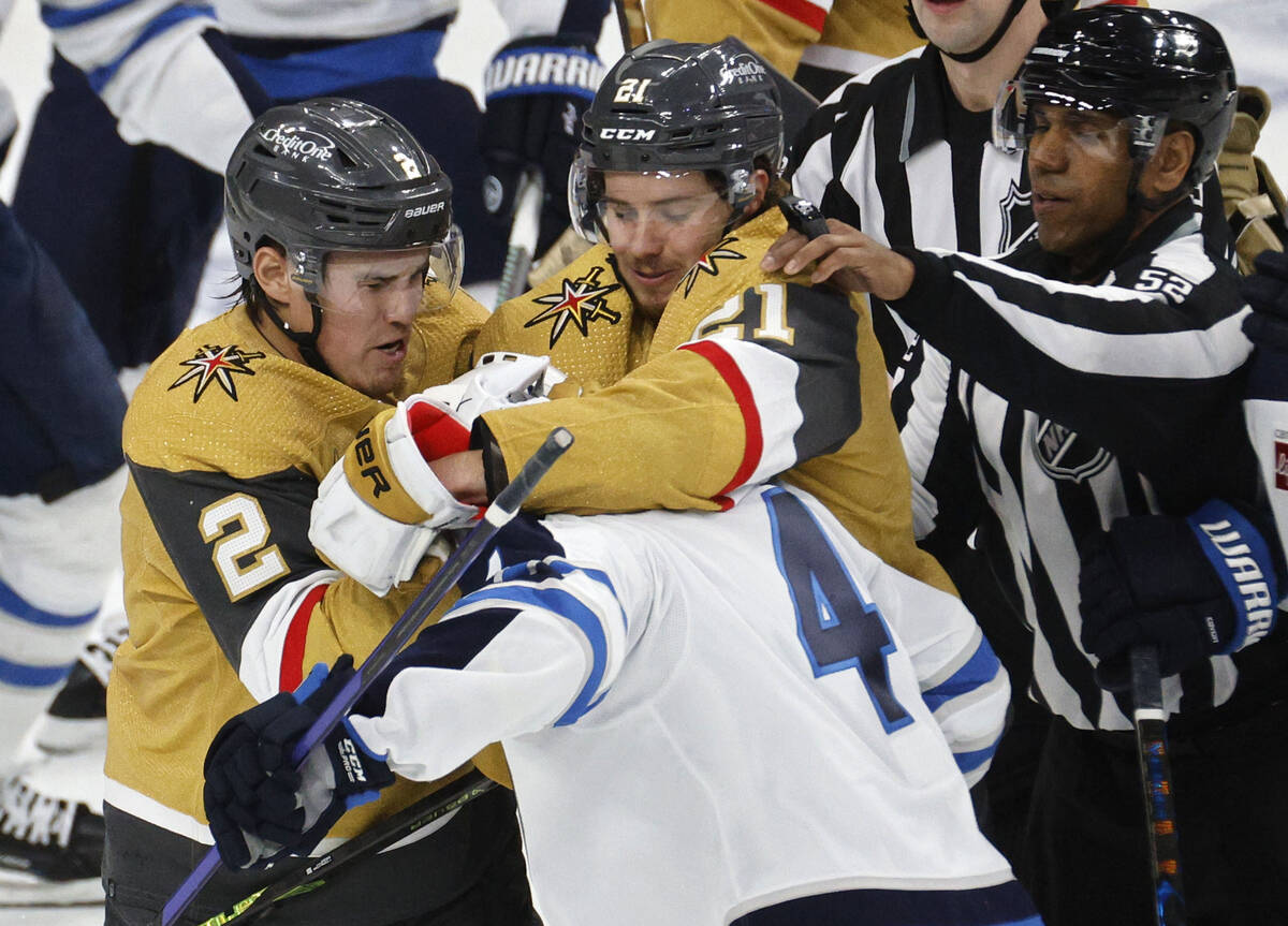 Golden Knights defenseman Zach Whitecloud (2) and Golden Knights center Brett Howden (21) figh ...