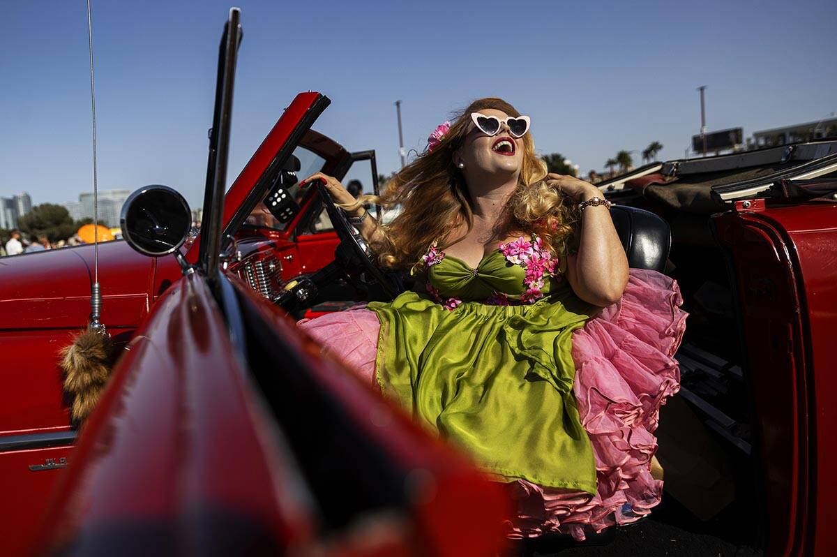 Jody Collins, from Sacramento, Calif., takes photos in a classic car during the Rockabilly Car ...