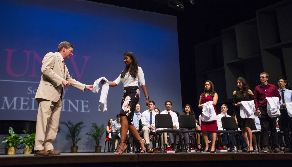 UNLV School of Medicine professor Jeffrey Fahl, left, looks to congratulate class of 2022 stude ...