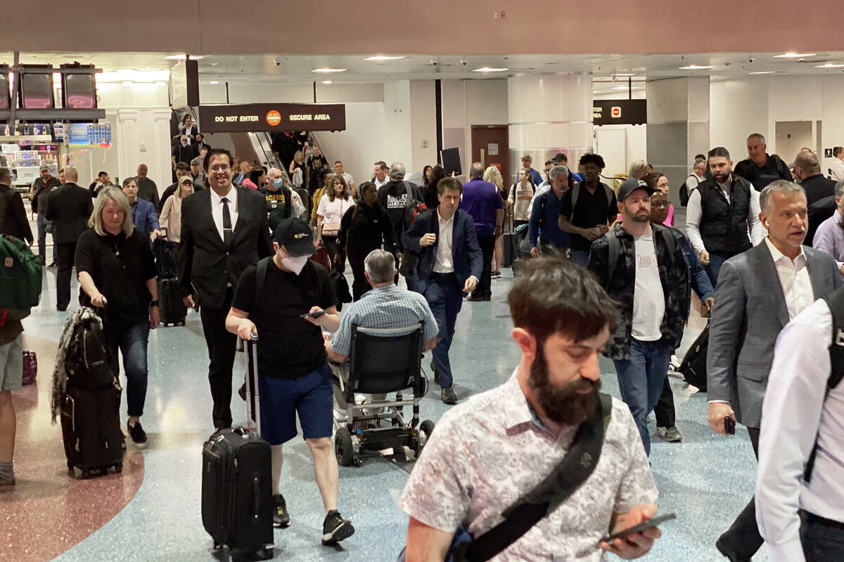 Passengers walk through terminal one at Harry Reid International Airport on Monday, April. 17, ...