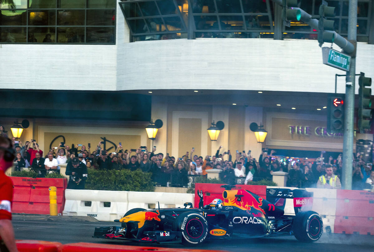 Racer Sergio Pérez turns doughnuts across from the Cromwell while waving to fans racing down t ...