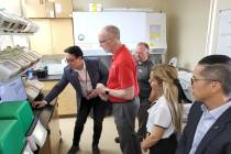 Edwin Oh, far left, shows Chris Heavy, center left, David Hatchett, center, researcher Joelyne ...