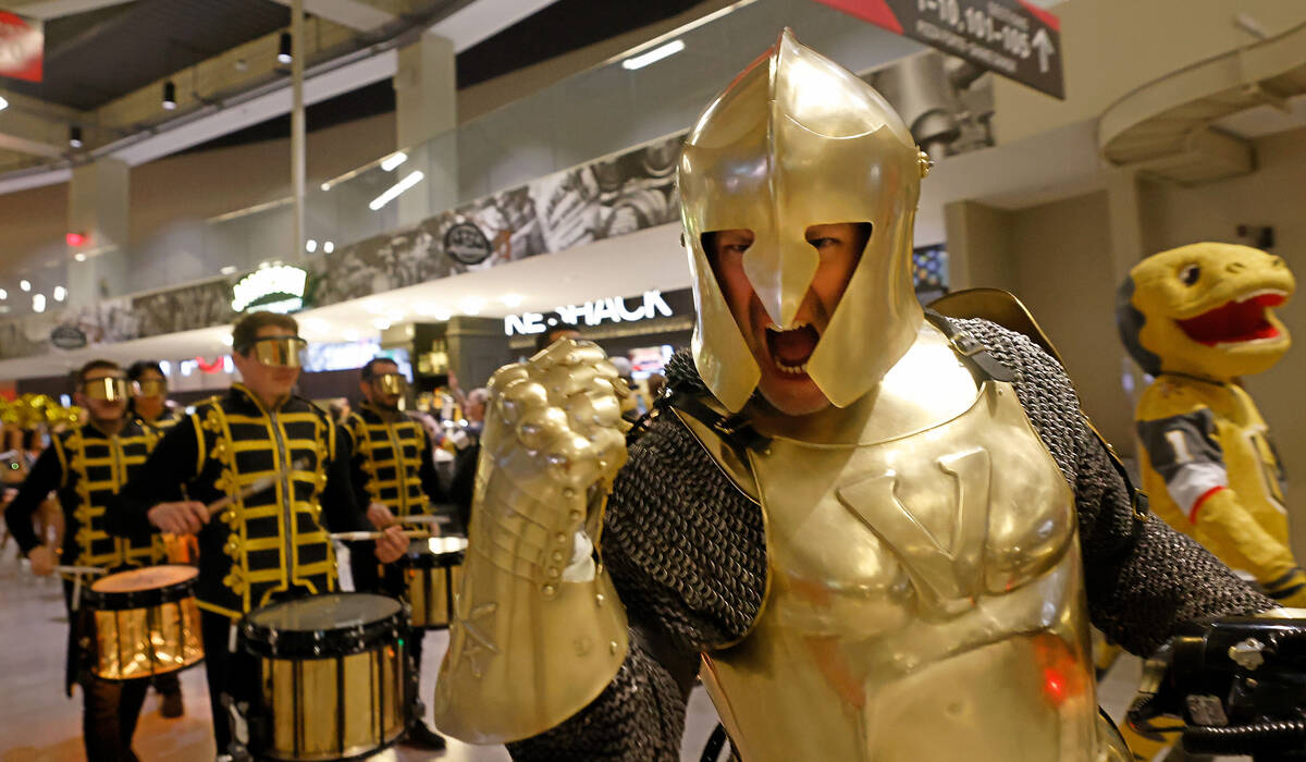 Lee Orchard as the Golden Knight pumps up the crowd as marching inside T-Mobile Arena before Ga ...