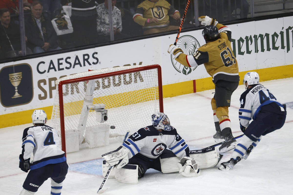 Winnipeg Jets goaltender Connor Hellebuyck (37) cannot stop a shot by Golden Knights right win ...