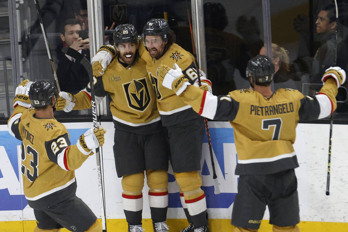 Golden Knights center Chandler Stephenson (20), second from left, celebrates his goal with Gold ...