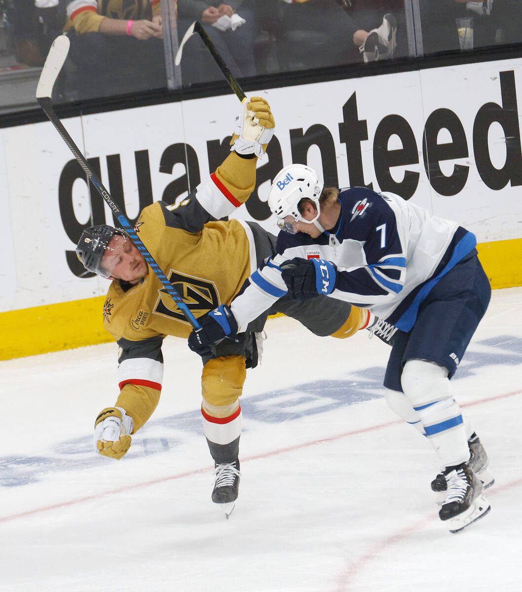 Golden Knights center Jack Eichel (9) tangles with Winnipeg Jets center Vladislav Namestnikov ( ...