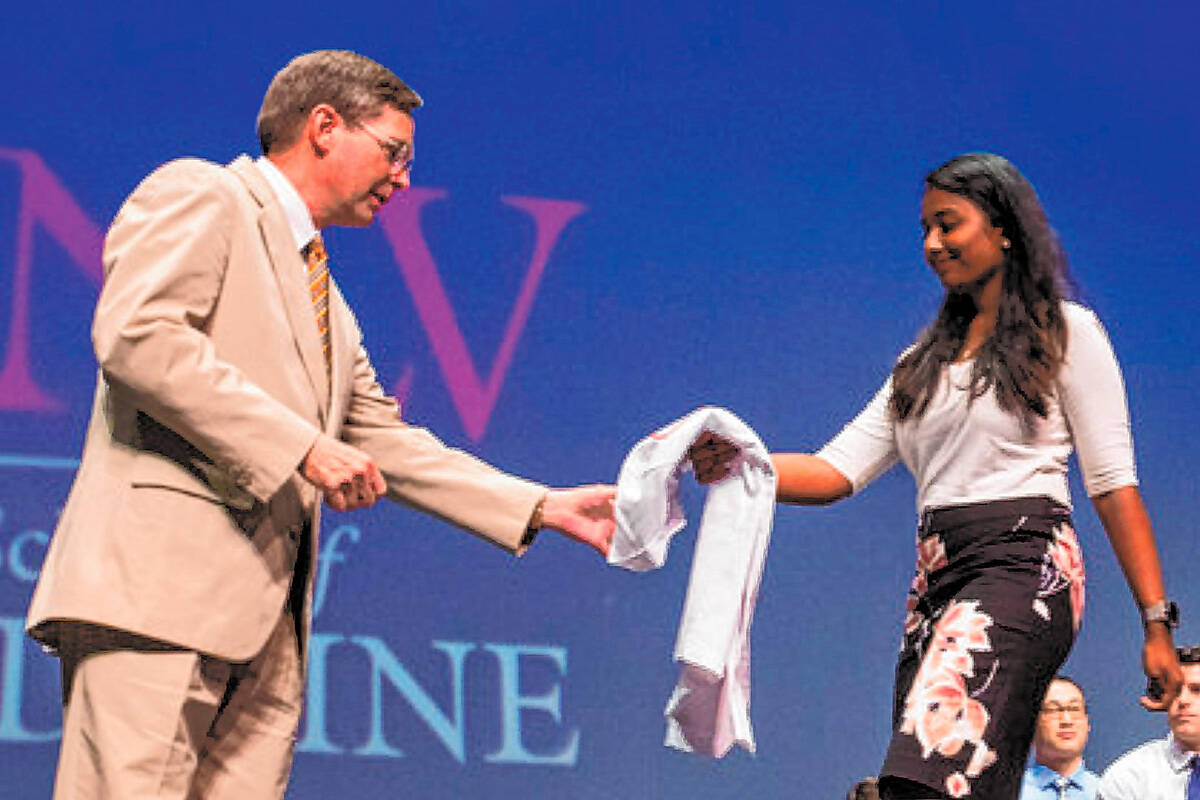 UNLV School of Medicine professor Jeffrey Fahl, left, looks to congratulate class of 2022 stude ...