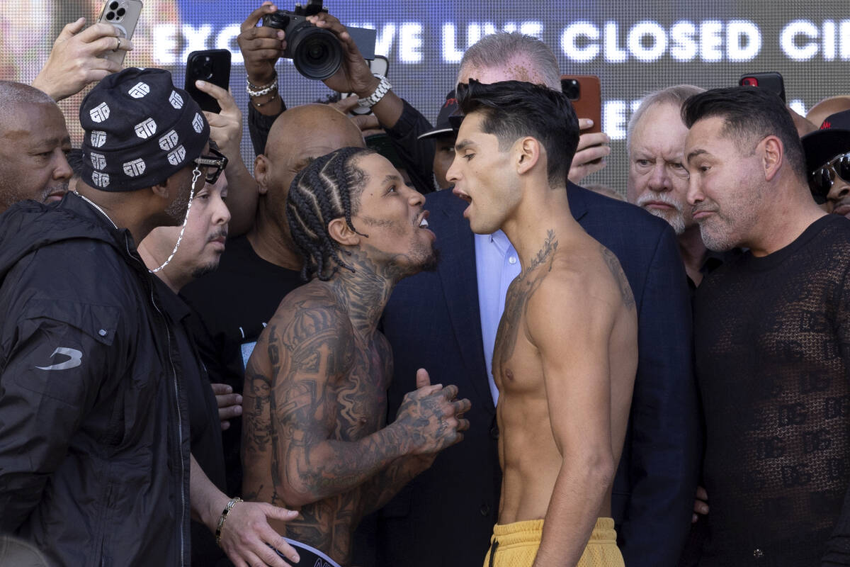 Gervonta Davis, center left, exchanges words with Ryan Garcia during their weigh-in at Toshiba ...