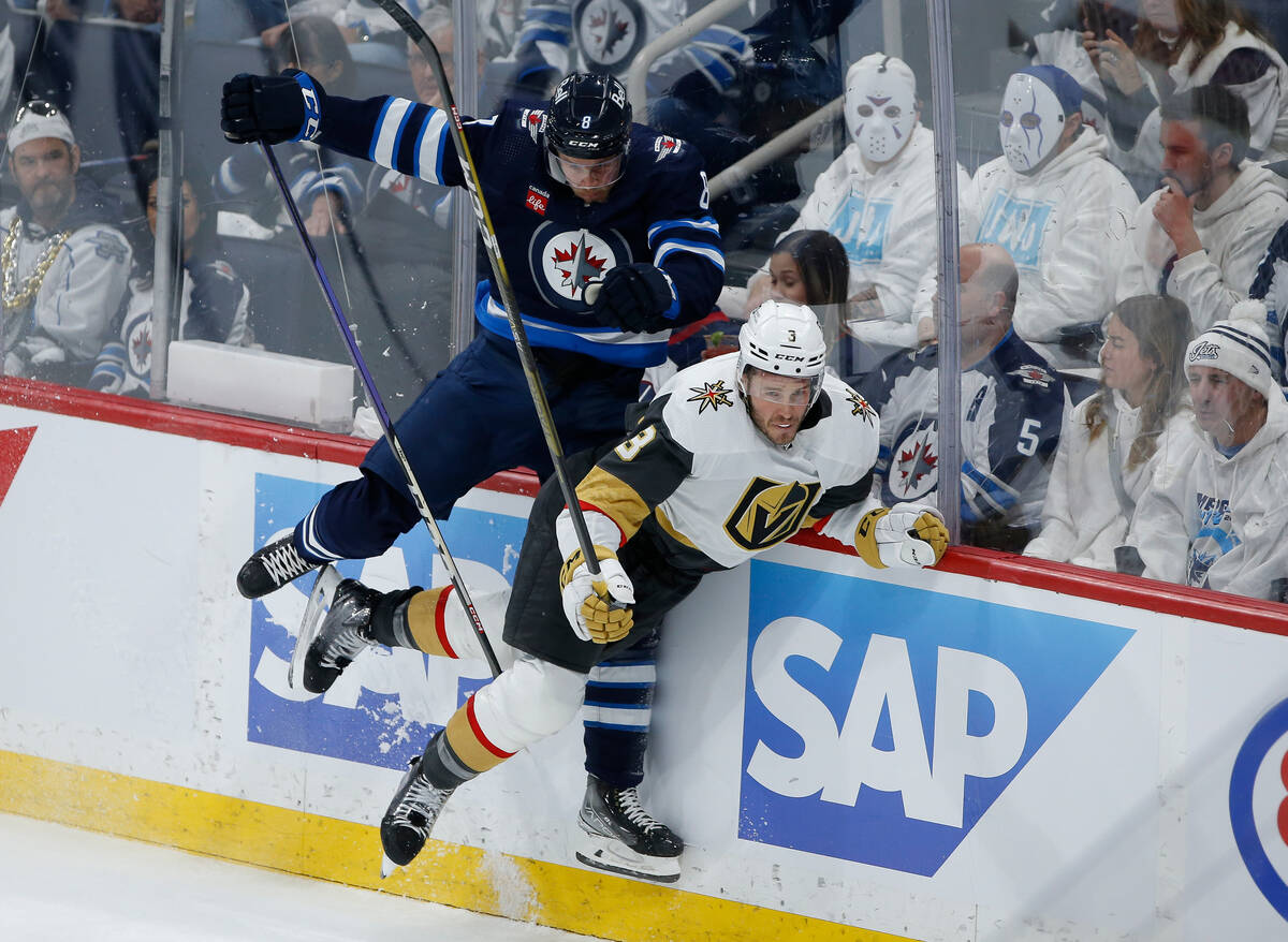 Winnipeg Jets' Saku Maenalanen (8) and Vegas Golden Knights' Brayden McNabb (3) collide during ...