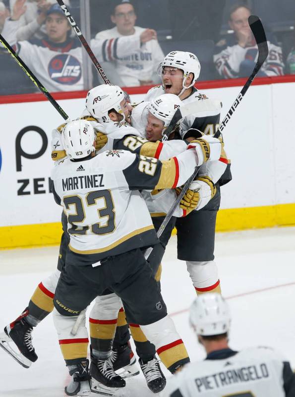 Vegas Golden Knights' Alec Martinez (23), Michael Amadio (22), Brett Howden (21) and Ivan Barba ...