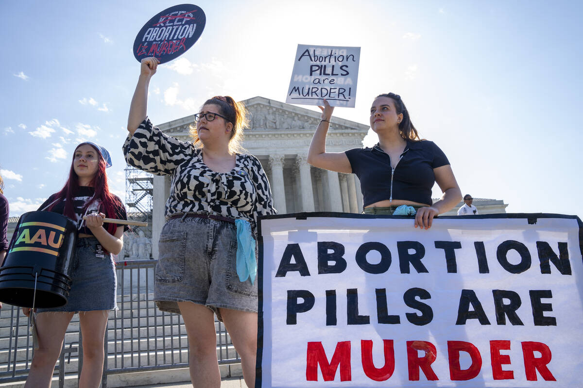 Staff with the group, Progressive Anti-Abortion Uprising, Kristin Turner, of San Francisco, lef ...