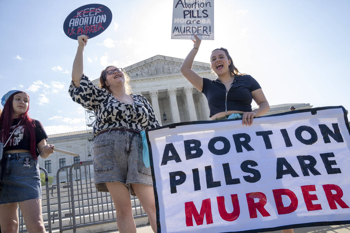 Staff with the group, Progressive Anti-Abortion Uprising, Kristin Turner, of San Francisco, lef ...