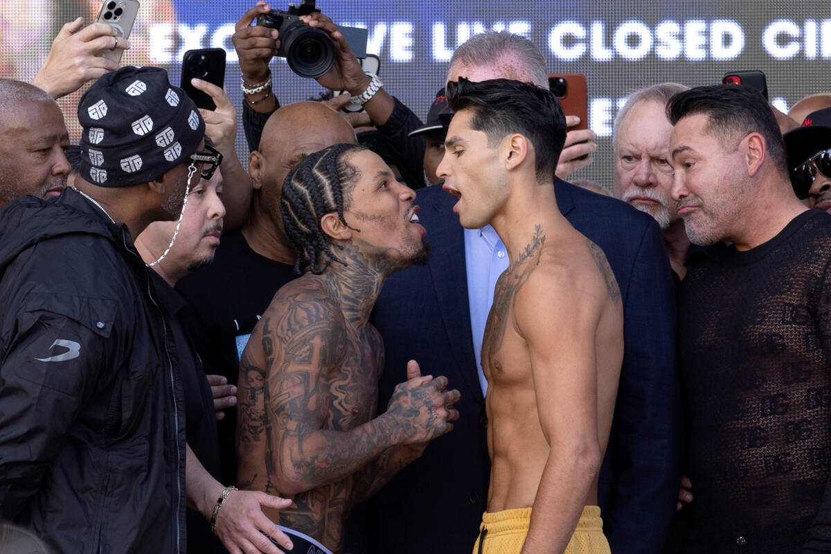 Gervonta Davis, center left, exchanges words with Ryan Garcia during their weigh-in at Toshiba ...