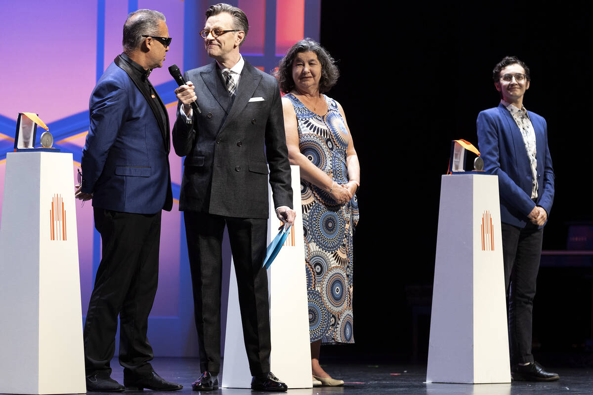 Host and broadway performer Jim Caruso asks honoree Darren Motamedy, an educator at Walter John ...