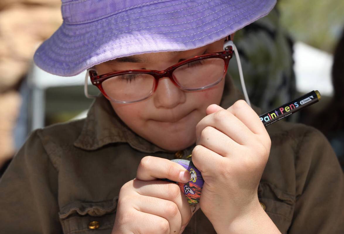 Sophia Alcarata, 7, paints a rock during an Earth Day festival at the Springs Preserve Saturday ...