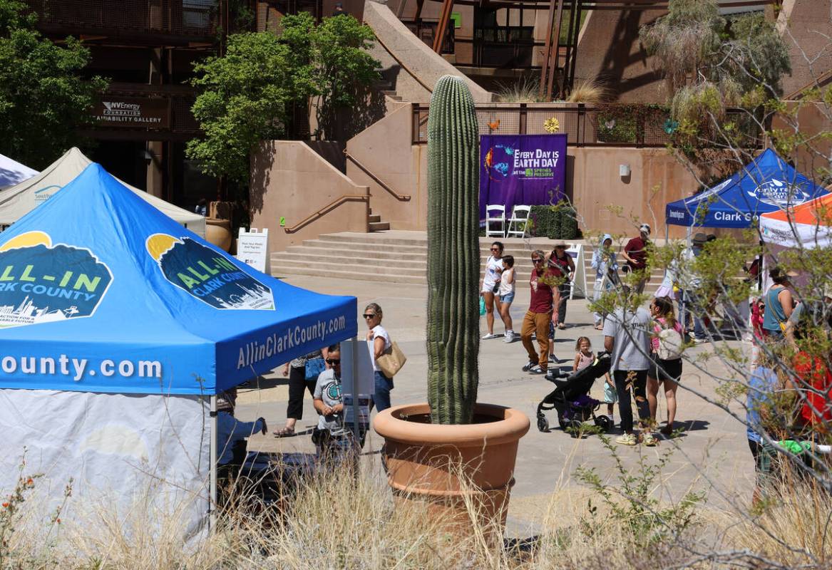 People walk by educational booths at an Earth Day festival at the Springs Preserve Saturday, Ap ...