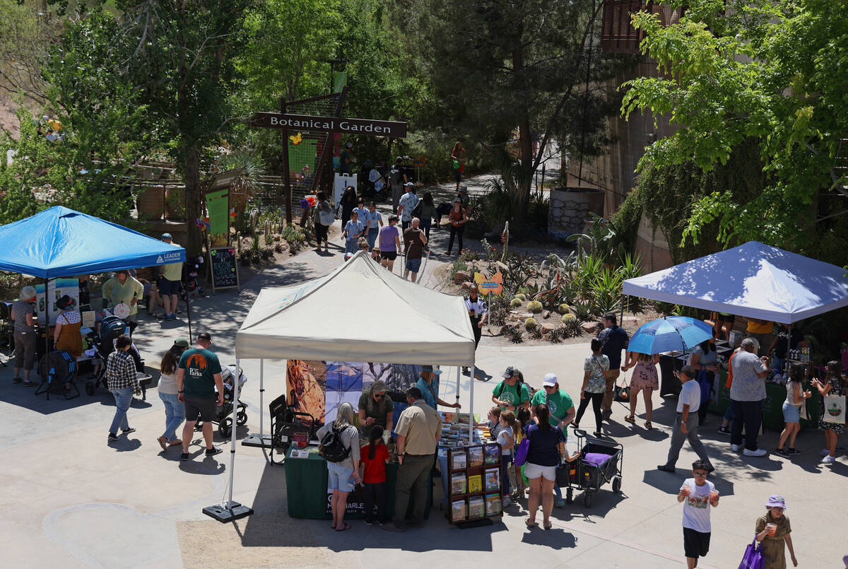 People walk by educational booths at an Earth Day festival at the Springs Preserve Saturday, Ap ...