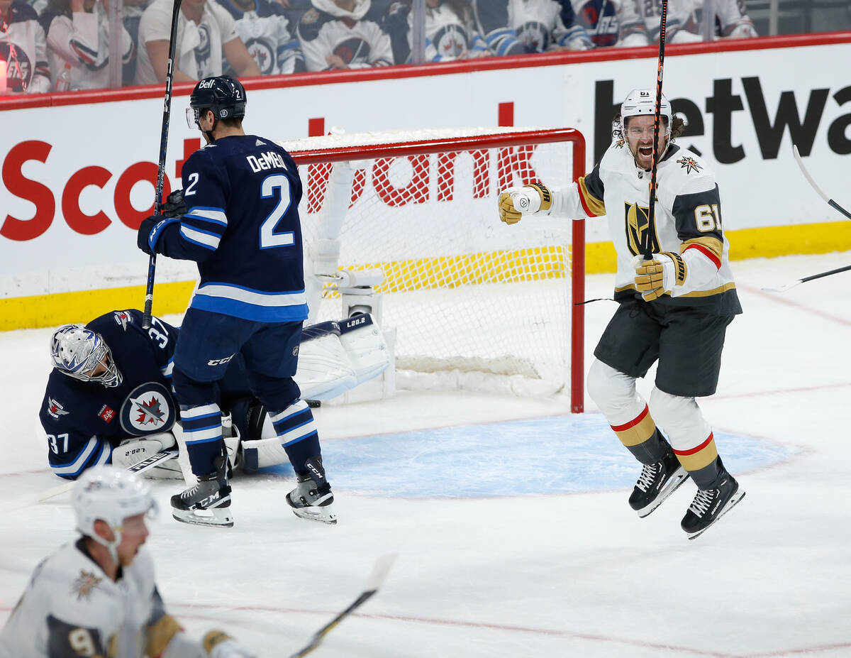 Vegas Golden Knights' Mark Stone (61) celebrates Jack Eichel's (9) goal against the Winnipeg Je ...