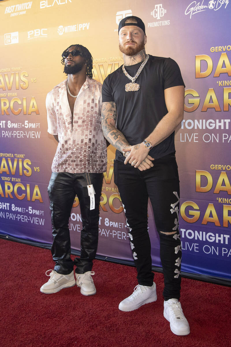 Raiders cornerback Nate Hobbs, left, poses with defensive end Maxx Crosby on the red carpet pri ...