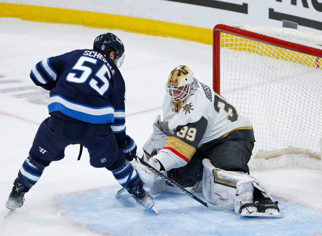 Vegas Golden Knights goaltender Laurent Brossoit (39) makes a save against Winnipeg Jets' Mark ...