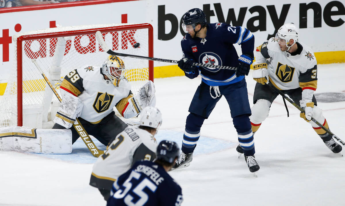 Winnipeg Jets' Blake Wheeler (26) watches as Mark Scheifele (55) scores on Vegas Golden Knights ...