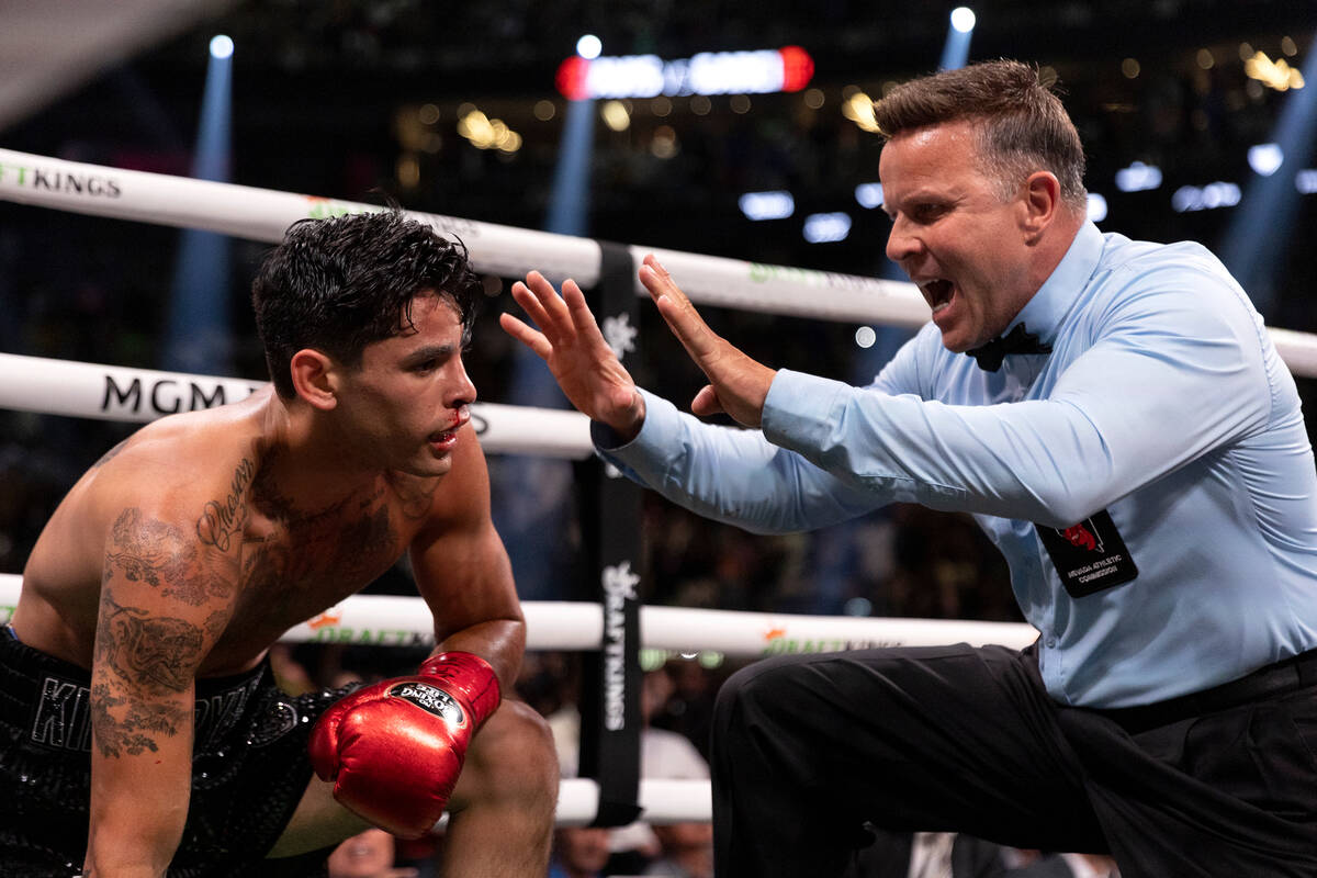 Referee Thomas Taylor calls a technical knock out on Ryan Garcia during a catchweight boxing bo ...