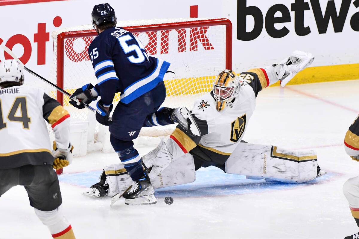 Vegas Golden Knights goaltender Laurent Brossoit (39) makes a save against Winnipeg Jets' Mark ...