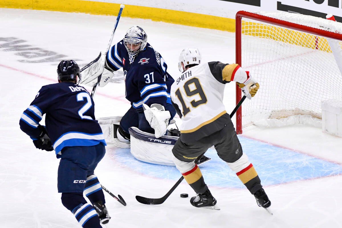 Winnipeg Jets goaltender Connor Hellebuyck (37) makes a save against Vegas Golden Knights' Reil ...