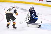 Vegas Golden Knights' Brett Howden (21) scores against Winnipeg Jets' goaltender Connor Hellebu ...