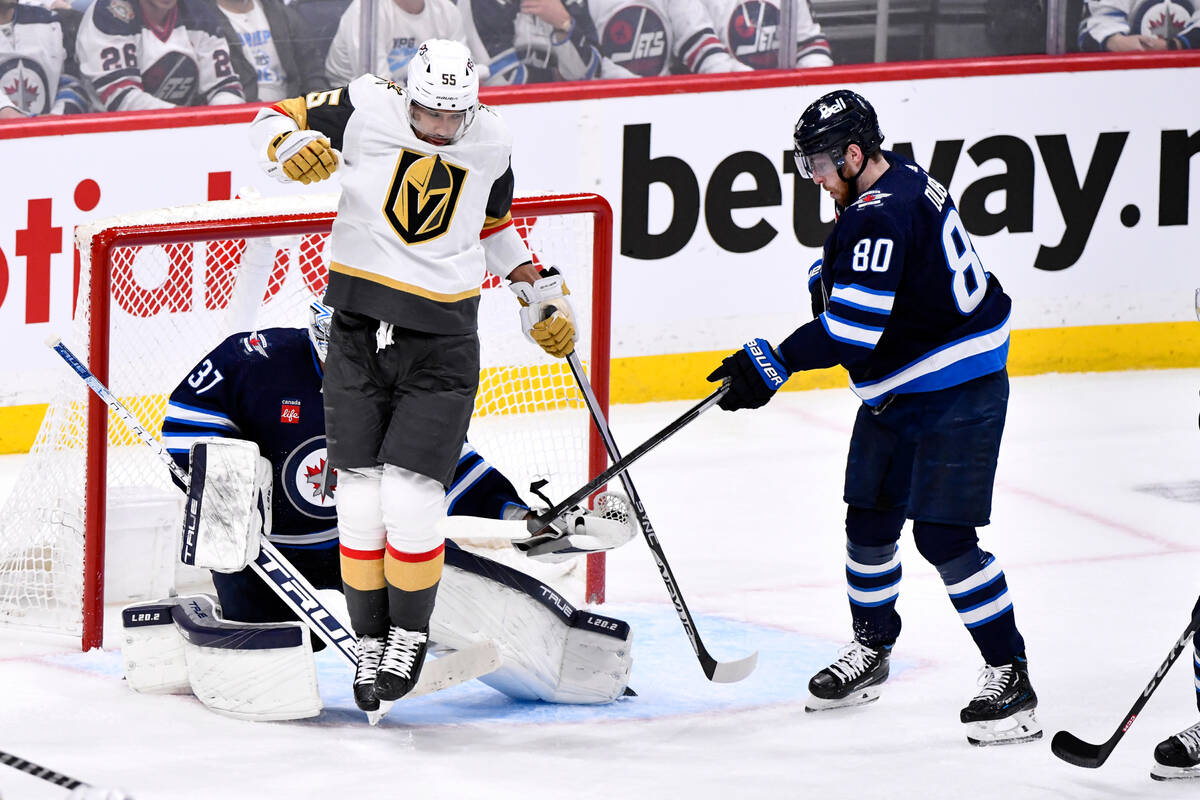 Winnipeg Jets' goaltender Connor Hellebuyck (37) makes a save as Vegas Golden Knights' Keegan K ...