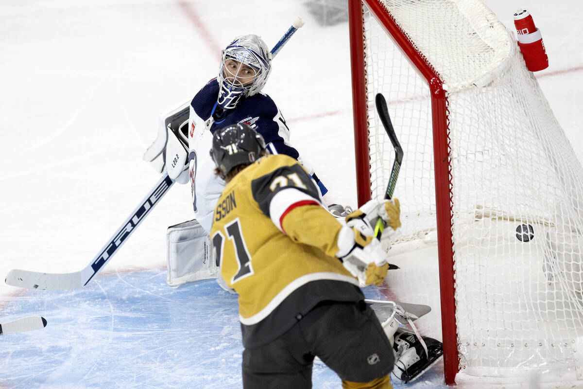 Golden Knights center William Karlsson (71) scores on Winnipeg Jets goaltender Connor Hellebuyc ...