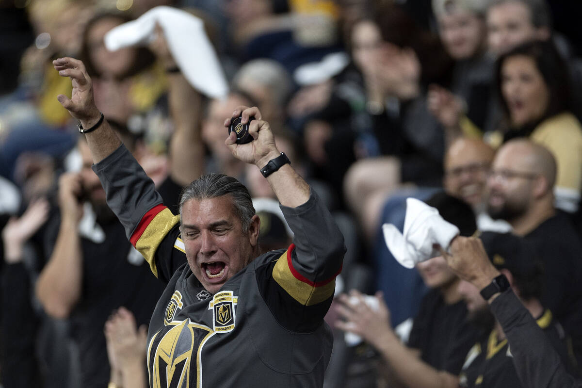 A Golden Knights fan celebrates after snagging a wayward puck during the third period in Game 5 ...